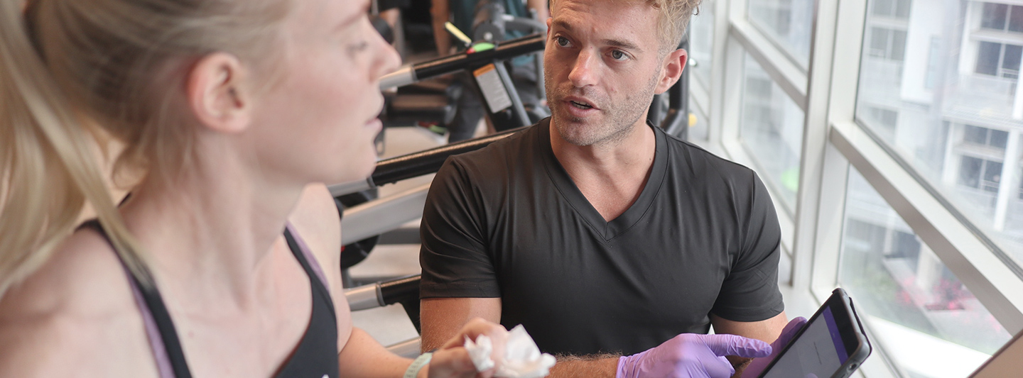 exercise physiologist assessing client on treadmill 