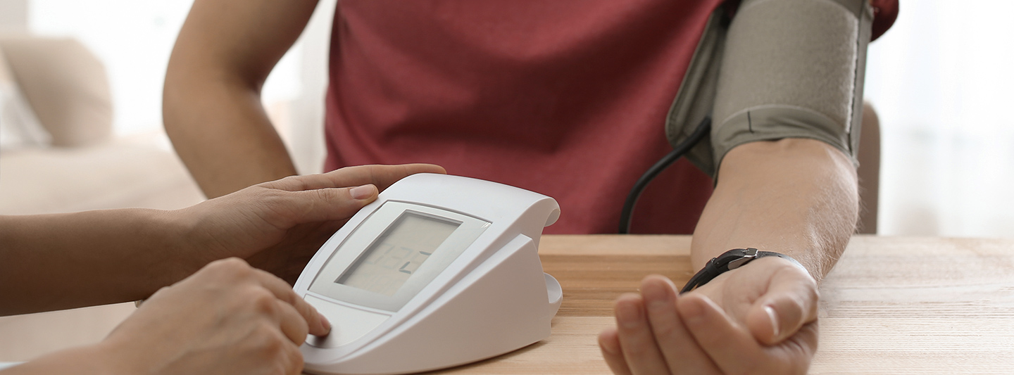 Lifestyle Assessment professional measuring blood pressure on client