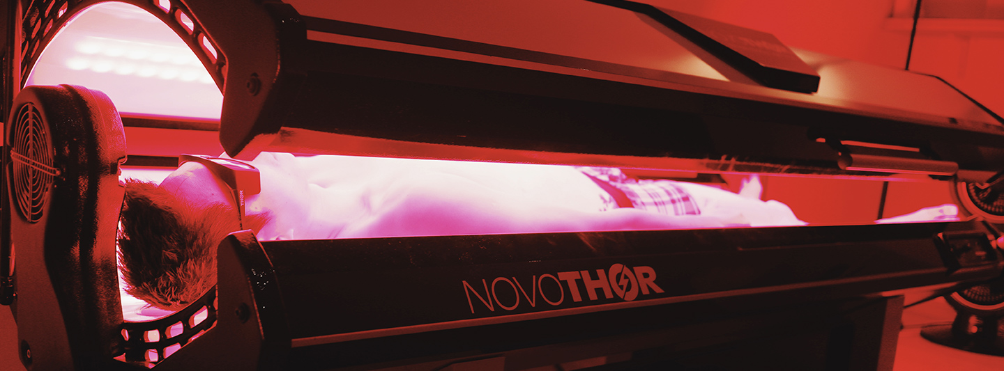 man in red light therapy bed