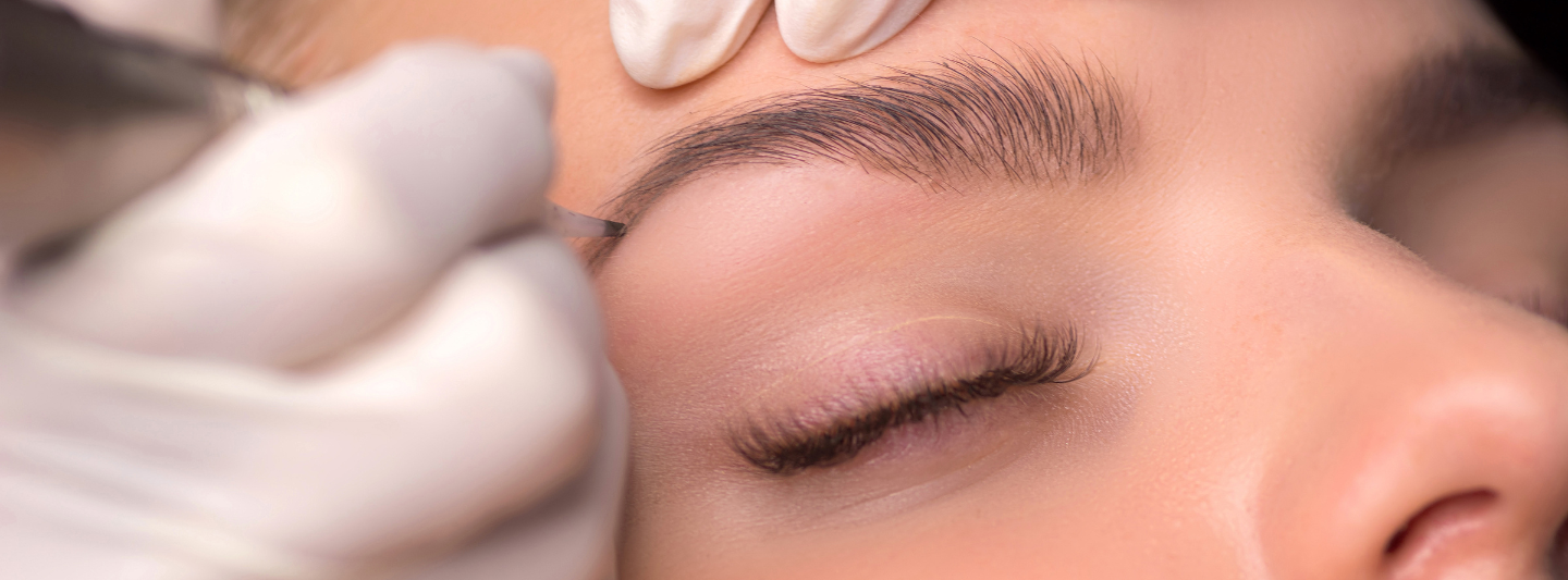 woman doing her eyebrows