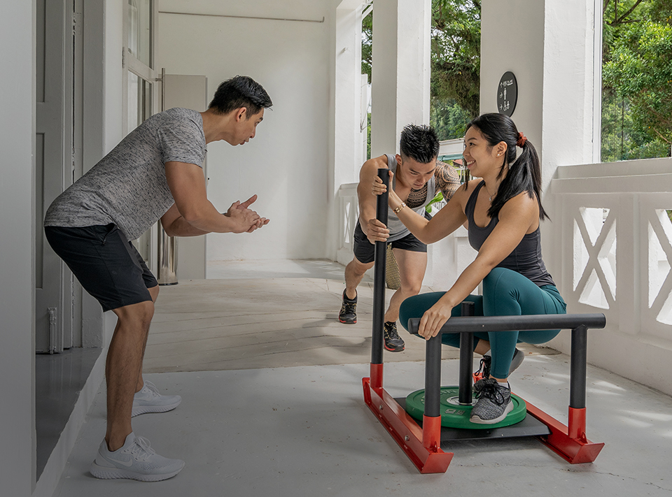 personal trainer and clients exercising outdoors