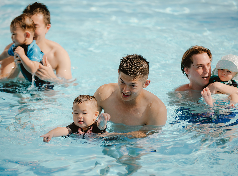fathers swimming with their sons