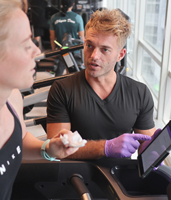 exercise physiologist assessing client on treadmill 